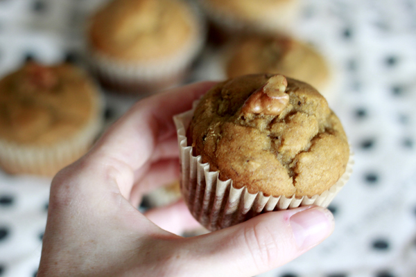 A walnut on top of a Peanut Butter Chocolate Chip Banana Bread muffin