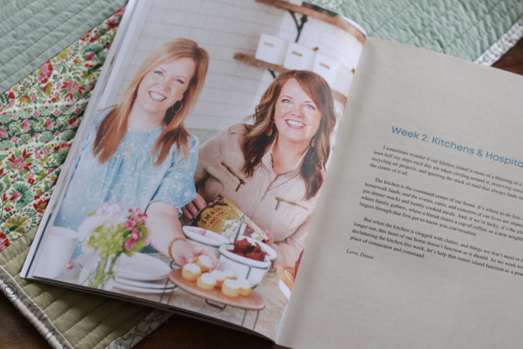 Dawn and Diana in the kitchen with cupcakes and snacks. Spread of the book is open to "week two kitchens and hospitality"