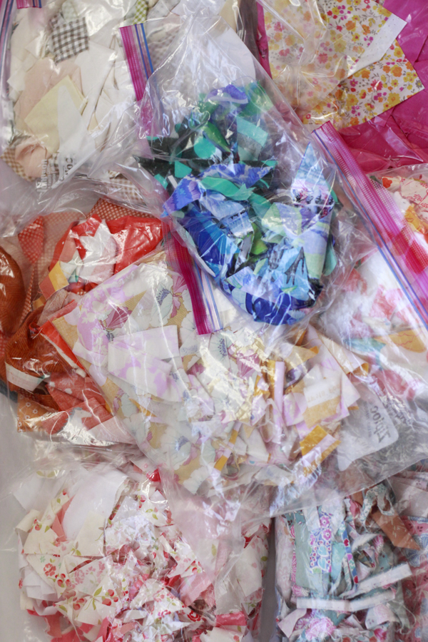 Ziplock bags filled with sorted fabric scrap of many different colors