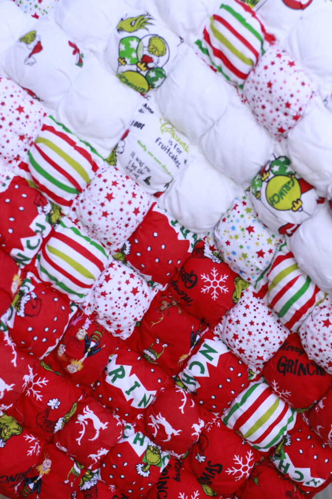 Christmas-themed, dr. suess puff quilt for baby. The squares are red, green and white