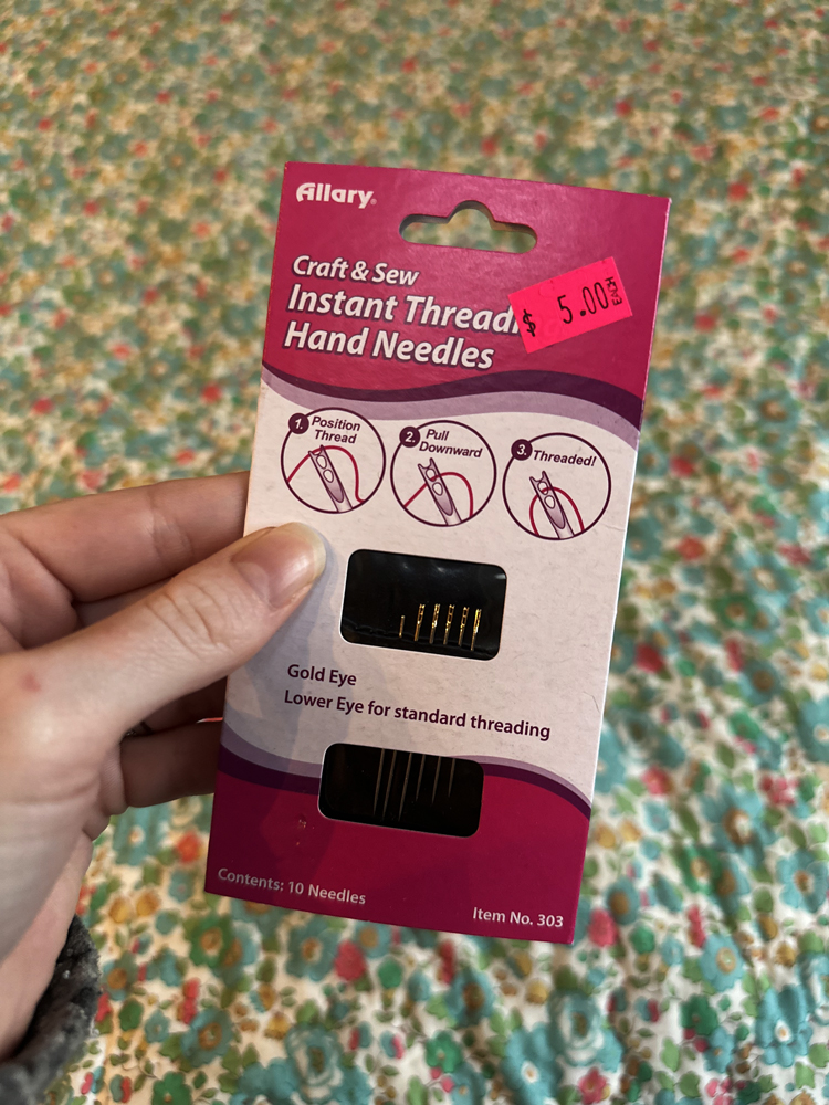 a pink package of instant thread hand needles 