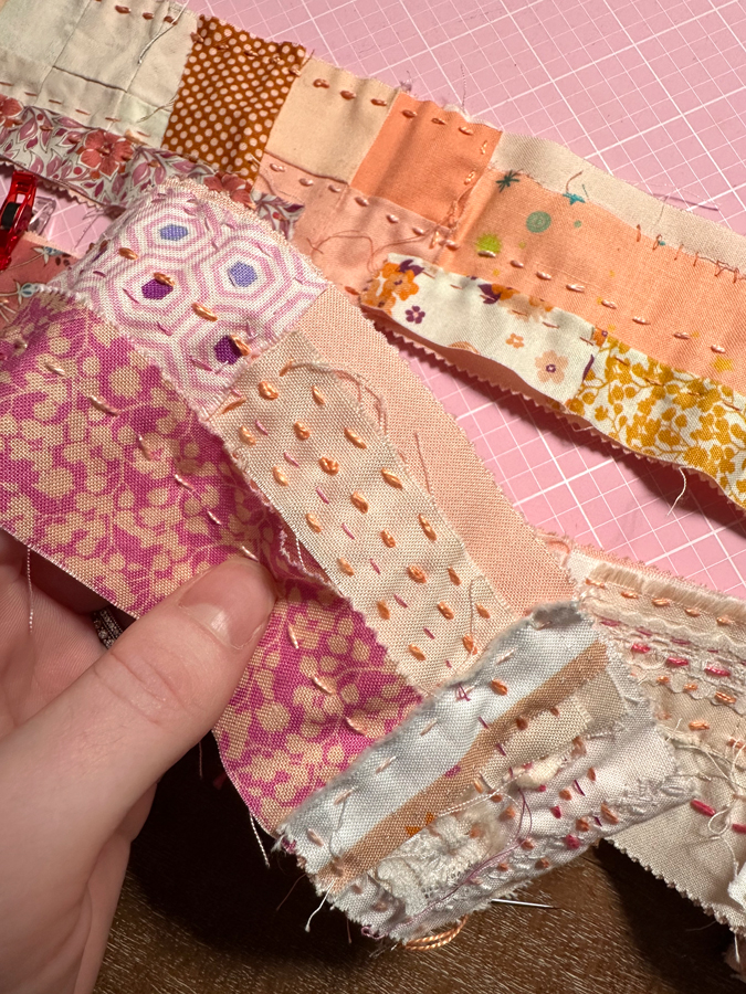 colorful scraps of fabric with straight stitching lines through it