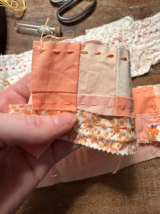 scraps of peach and orange fabric with straight stitching through it