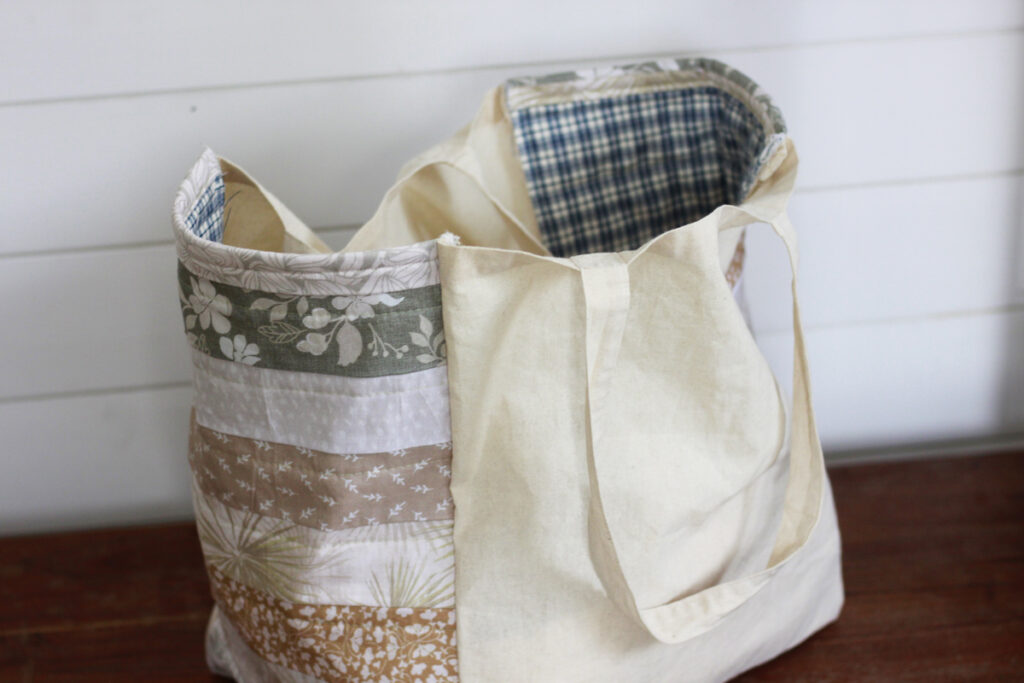 Finished canvas bag with quilted floral ends and blue plaid on the inside.