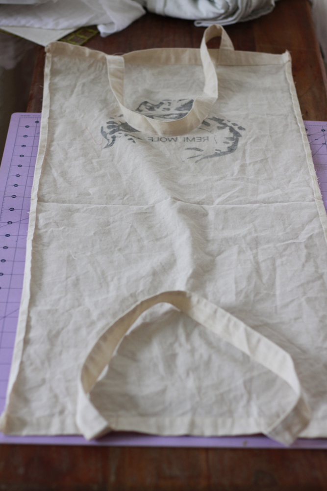 A canvas bag is stretched out with it's seams open.