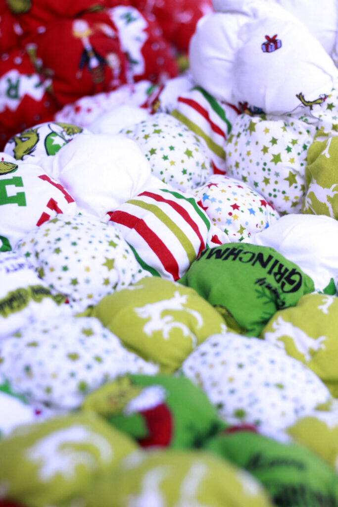 the grinch fabric sewn into puffy squares, ombre design green, white and reds.