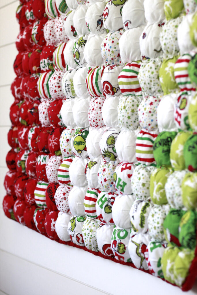 Ombre quilt design fades red to white to green in christmas grinch themed fabric