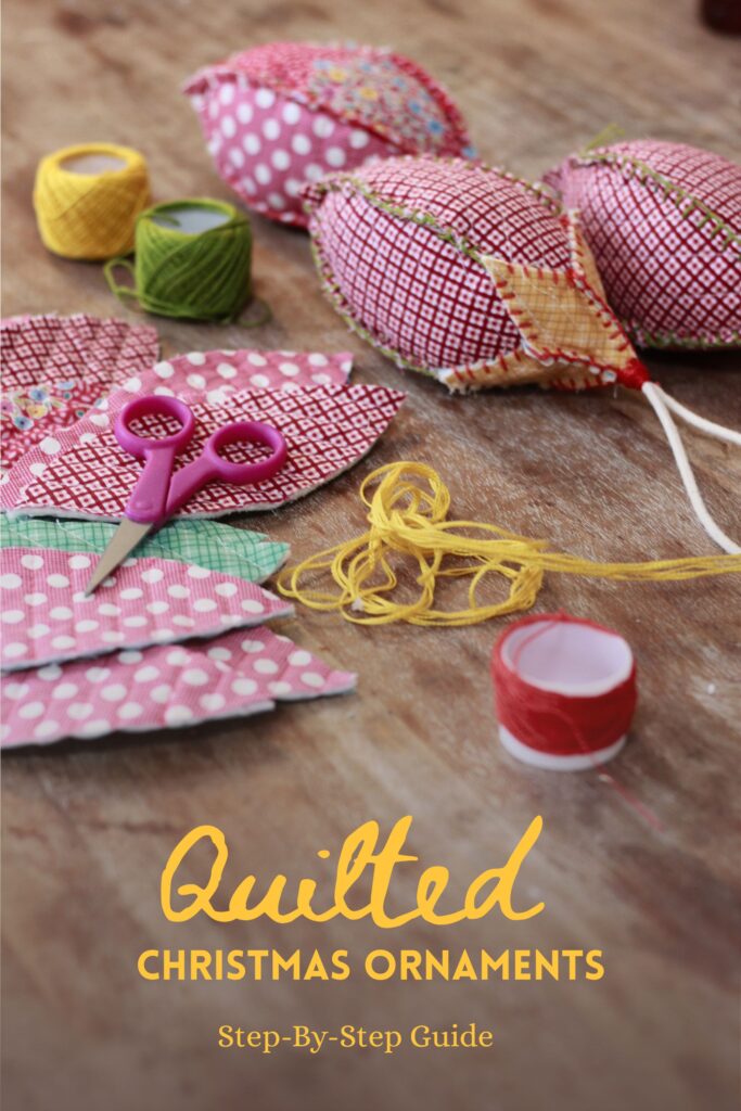 supplies spread out on the table, threads, scissors, quilted fabric in christmas theme